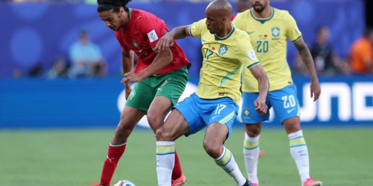 Ayyoub Bouaddi, número 6 do Marrocos, disputa a bola com Fabinho, número 17 do Brasil — Foto: Getty Images via AFP
