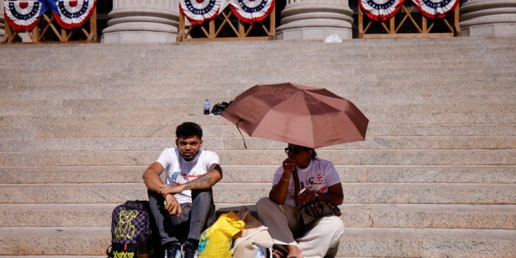 Pessoas sentam-se em escadas no centro de Manhattan durante uma onda de calor na cidade de Nova York, em 3 de julho de 2026 — Foto: LEONARDO MUNOZ / AFP
